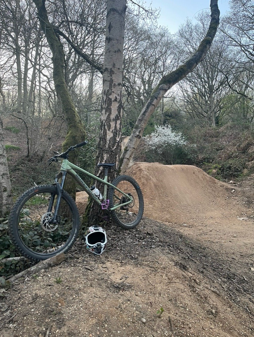 Seb Banham mountain bike beside a Danbury Common dirt jump